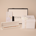 Load image into Gallery viewer, Fevani makeup products including a box, pencil, and other items on a beige background