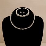 Load image into Gallery viewer, Pearl necklace and earrings set on a black bust against a beige background