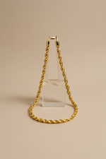 Load image into Gallery viewer, Gold chain necklace on a beige background
