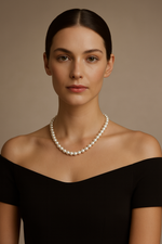 Last inn bildet i gallerivisningen, Woman wearing a pearl necklace against a neutral background
