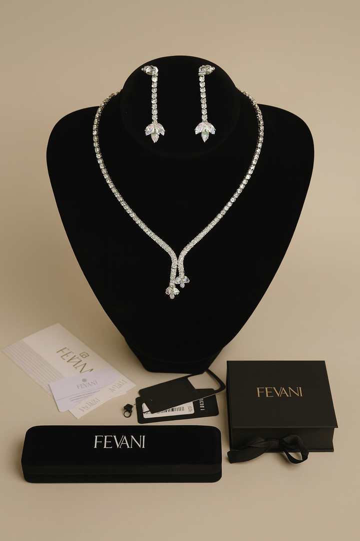 Jewelry set with necklace and earrings on a black stand, accompanied by FEVANI packaging and accessories.