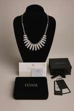 Afbeelding in Gallery-weergave laden, Fevani necklace on a black mannequin bust with packaging and accessories.
