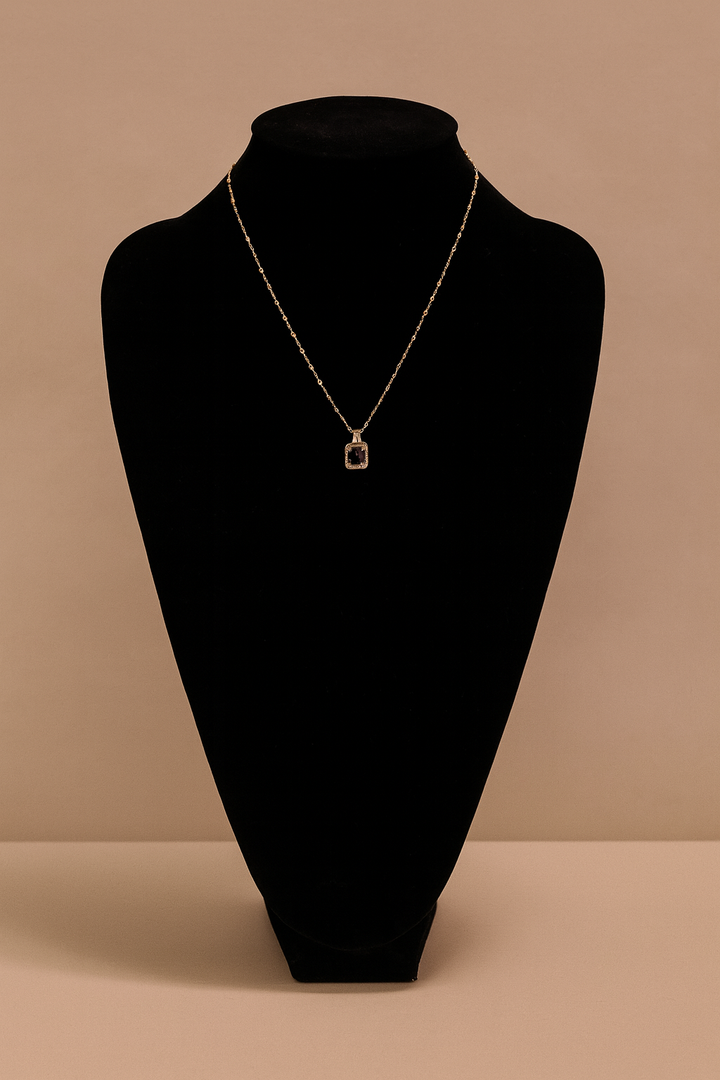 Necklace with a pendant on a black mannequin bust against a beige background