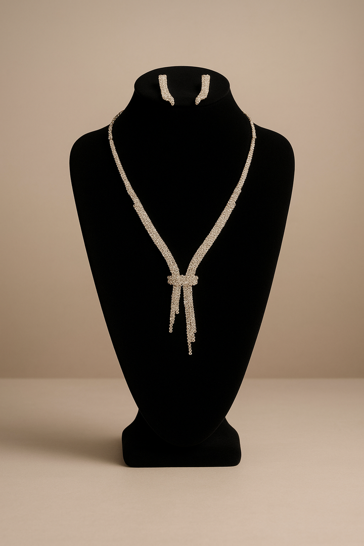 Necklace on a black mannequin bust against a beige background