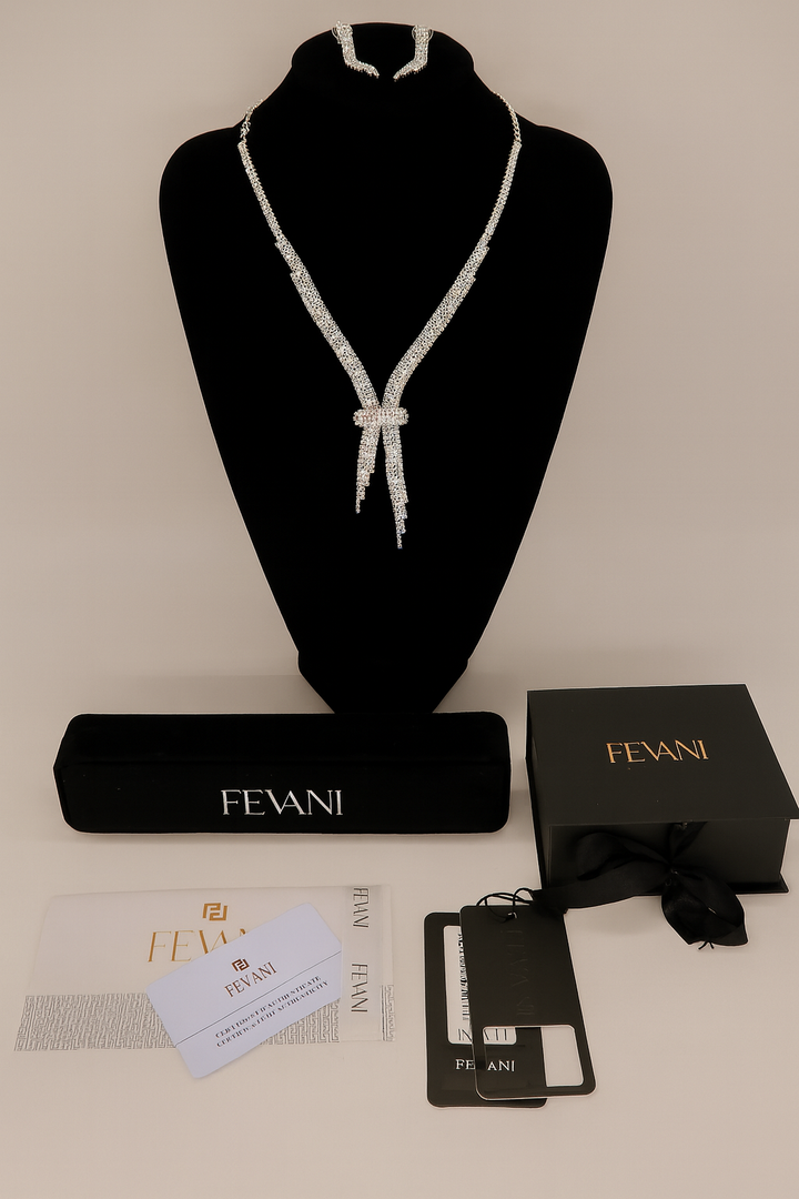 Pearl necklace on a black stand with FEVANI packaging and accessories on a beige surface