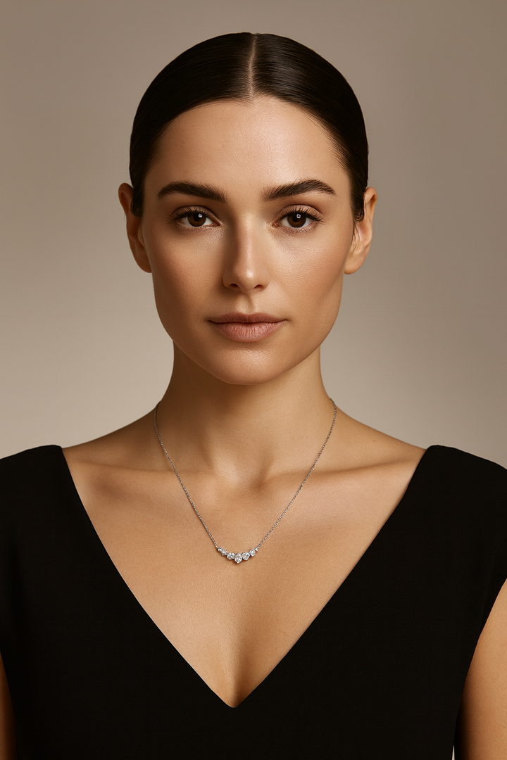 Woman wearing a necklace against a neutral background